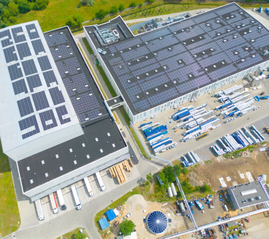 aerial view of modern storage warehouse with solar panels on the